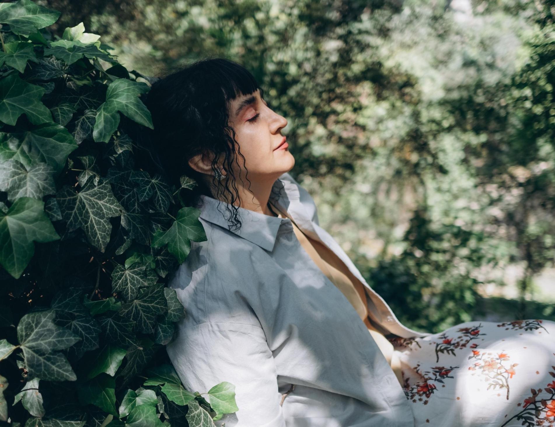 Woman leaning back in leaves