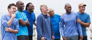 A group of men standing together and laughing.